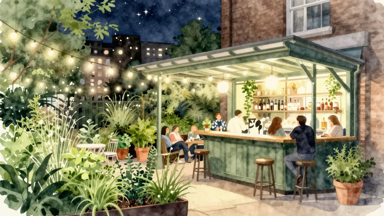 Cowshed garden bar with fairy lights and herb garden under open roof